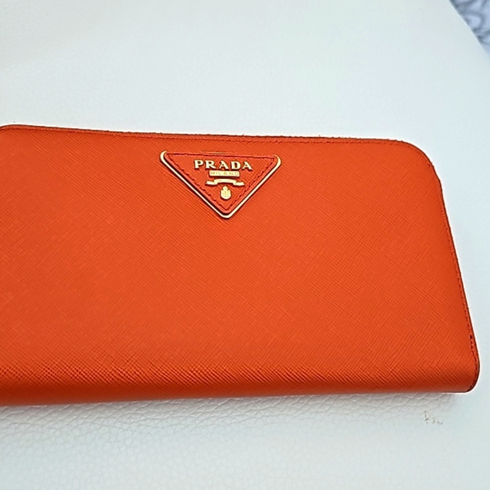 Prada women's large zip around wallet. Saffiano leather. Bill and card slots.